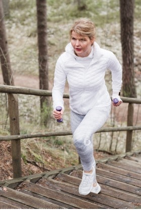 woman-climbing-stairs-during-exercise-outdoors