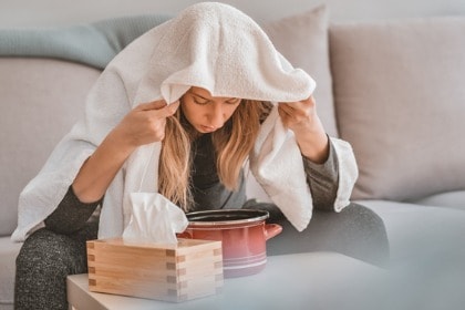 sick-woman-sitting-on-couch-steam-inhalation-with-essential-oils-for-respiratory-health