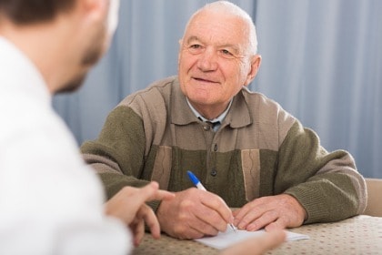 elderly-man-filling-out-survey