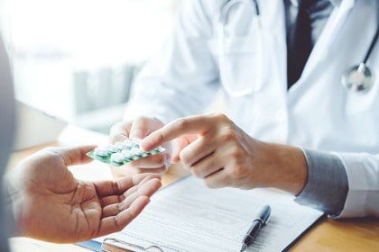 doctor-recommending-pills-medical-prescription-to-male-patient