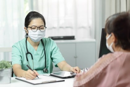 female-doctor-consulting-with-patient-writing-prescription
