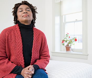 One woman with her eyes closed in a White Room