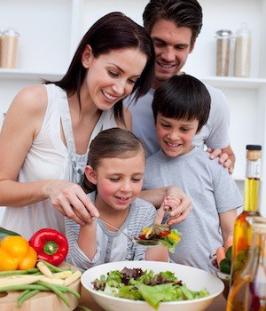 Family making salad with fiberous prebiotic veggies