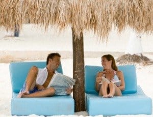 couple at beach under umbrella