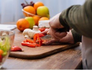 man chopping raw vegetables