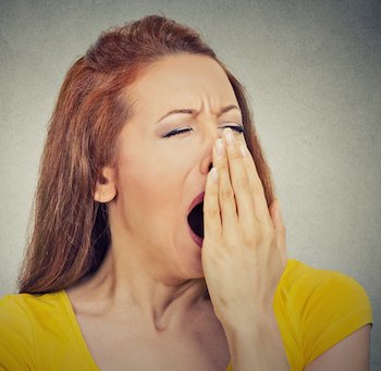 sleep deprived woman yawning